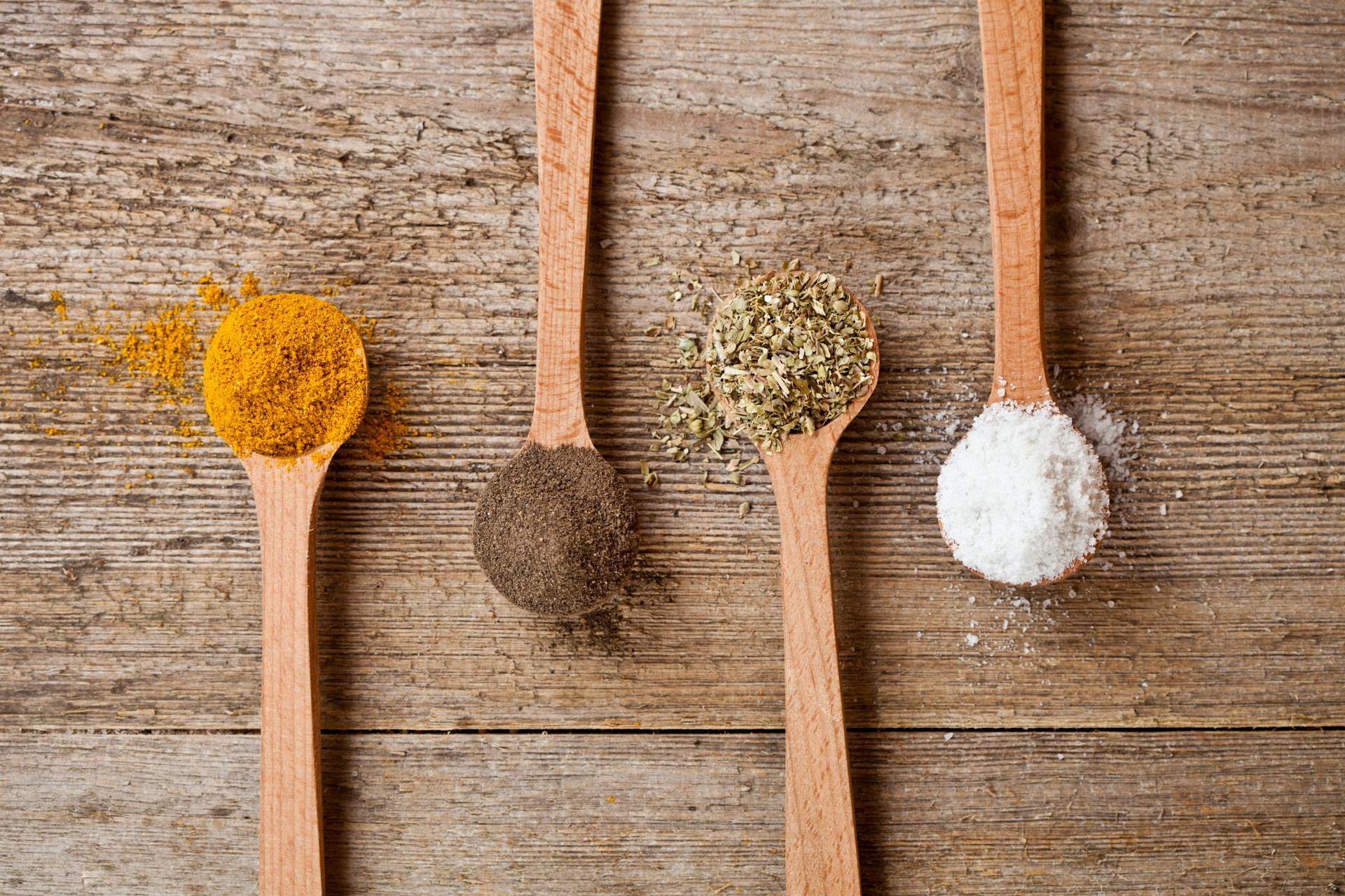 Vibrant spices and herbs artfully arranged on a textured round plate